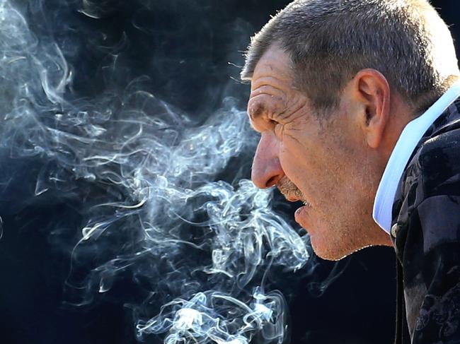 a man smoking at Redfern Oval , Sydney. pic mark evans