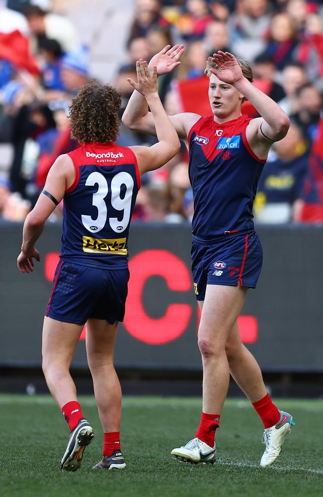 Jacob van Rooyen of the Demons celebrates with Koltyn Tholstrup after a goal. Picture: Graham Denholm/AFL Photos/via Getty Images.