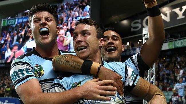 James Maloney of the Sharks celebrates with his team mates after scoring a try.