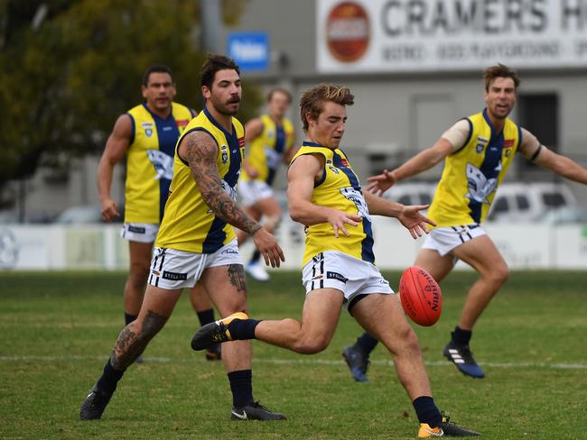 Michael Debenhamn (centre) of Mornington kicks the ball during the AFL Community Championships match at Preston Oval, Melbourne, Saturday, May 19, 2018. Northern Football League v Mornington Peninsula Football League. (AAP Image/James Ross) NO ARCHIVING