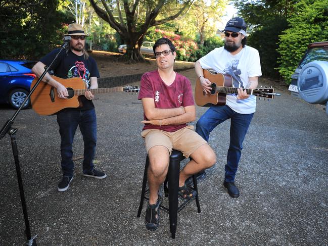 Terranorra man Sam Cleaver, 29, (centre) with musicians Bradley Ledwidge and Scott Whitford as they play a street jam session in the Tweed. Photo: Scott Powick