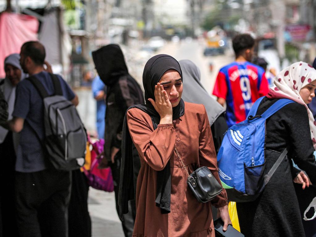 A woman weeps as she waits to evacuate Rafah in the southern Gaza Strip. Picture: AFP