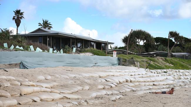 A beachfront home protected by temporary sandbags at Belongil.