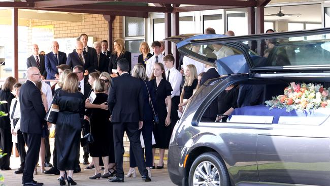 The Ahern family embrace, at the State Funeral Service for Mike Ahern AO, at Our Lady of the Rosary Catholic Church, Caloundra, on Friday 25th August 2023 - Photo Steve Pohlner