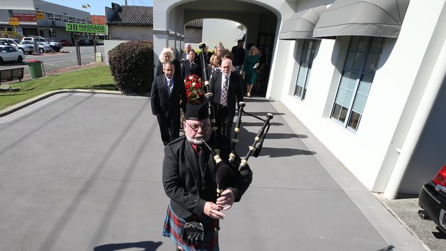 A piper leads mourners out of the chapel. Picture Glenn Hampson
