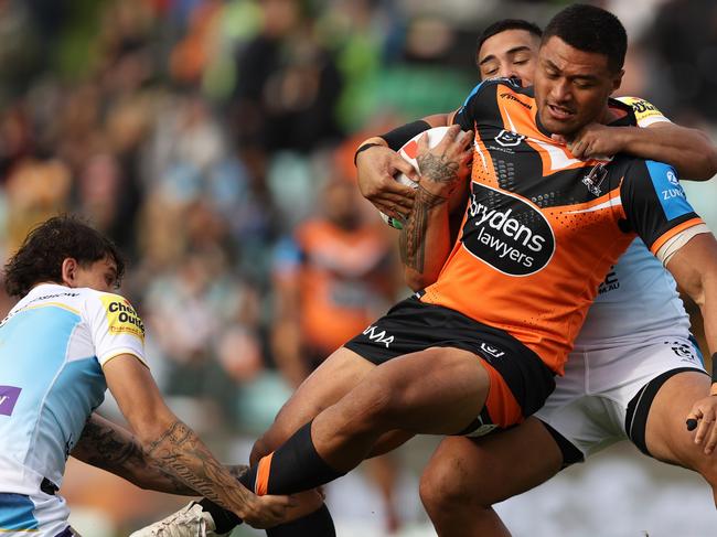 SYDNEY, AUSTRALIA - JUNE 15: Stefano Utoikamanu of the Wests Tigers is tackled during the round 15 NRL match between Wests Tigers and Gold Coast Titans at Leichhardt Oval on June 15, 2024 in Sydney, Australia. (Photo by Jason McCawley/Getty Images)