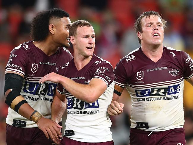 BRISBANE, AUSTRALIA - AUGUST 20: Haumole Olakau'atu, Daly Cherry-Evans and Jake Trbojevic of the Sea Eagles celebrate after victory during the round 23 NRL match between the Canberra Raiders and the Manly Sea Eagles at Suncorp Stadium, on August 20, 2021, in Brisbane, Australia. (Photo by Chris Hyde/Getty Images)
