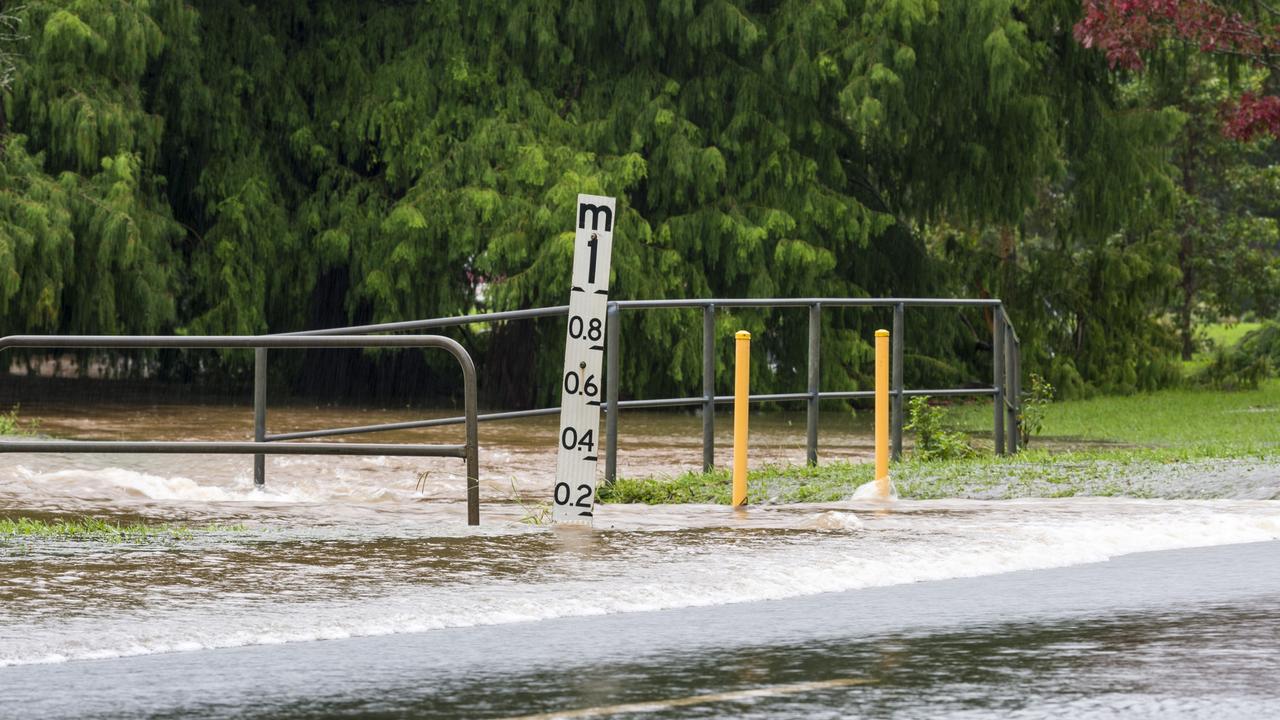 Water over the road closes Mackenzie Street as East Creek flows over near the South Street intersection, Tuesday, March 23, 2021. Picture: Kevin Farmer