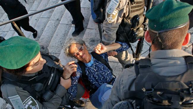 Members of the Israeli security forces detain a woman as they disperse a demonstration outside the Damascus Gate in the old city of Jerusalem. Picture: AFP