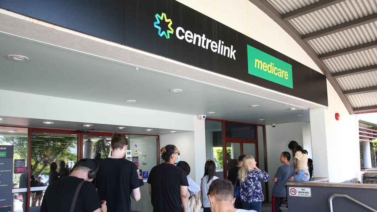 Lines of people wait at Southport Centrelink. Picture: Adam Head.