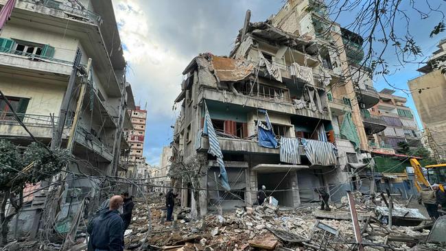 People inspect the damage at the site of overnight Israeli airstrikes that targeted the neighbourhood of Ghobeiry in Beirut’s south on Monday. Picture: AFP