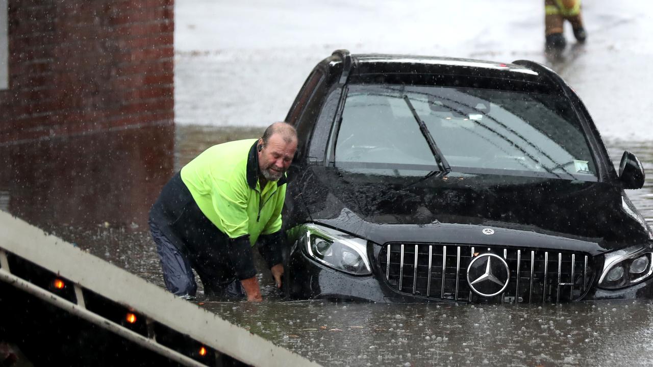 A car is rescued from flood waters in York St, South Melbourne. Picture: David Crosling