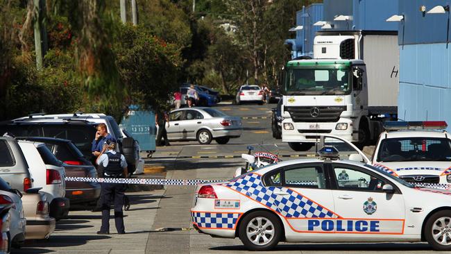 Police officers rope off a large area of the rear car park at Stockland Shopping Centre, Burleigh Heads, after numerous bomb threats were phoned through to police.