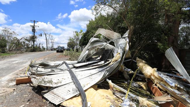 Roofing scattered across the road at Eagle Heights, Mt Tambourine. Picture: NCA NewsWire / Scott Powick