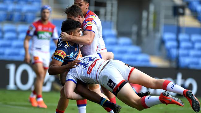 Tyrone Peachey is tackled during the victory over Newcastle — where he was tried just about everywhere on the park. Picture: Getty