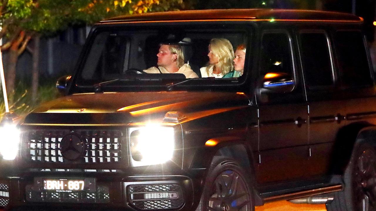 Jackson Warne drives with his sister and mother Simone Callahan also seen in the car. (Photo by Aaron FRANCIS / AFP)