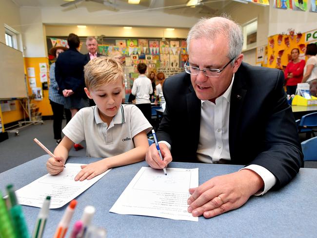 Prime Minister Scott Morrison interacts with a student during a visit to Galilee Catholic Primary School in Sydney, Friday, September 21, 2018. Prime Minister Scott Morrison has struck a $4.6 billion peace deal with Catholic and independent schools, which over a decade he says will bring to an end a long-running war over the Gonski 2.0 school funding model. (AAP Image/Joel Carrett) NO ARCHIVING