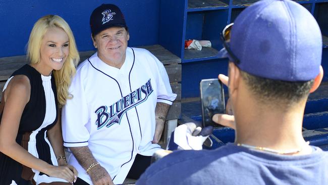 Pete Rose poses for a photo with ESPN reporter Britt McHenry after an interview prior to managing the game for the Bridgeport Bluefish against the Lancaster Barnstormers at The Ballpark at Harbor Yard in Bridgeport, Connecticut, in 2014. Picture: Christopher Pasatieri/Getty Images)