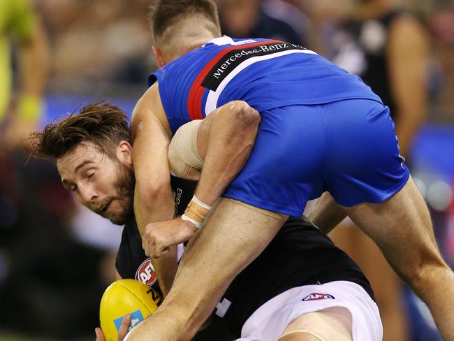 Dale Thomas gets taken over the boundary line by Matthew Suckling. Picture: Michael Klein