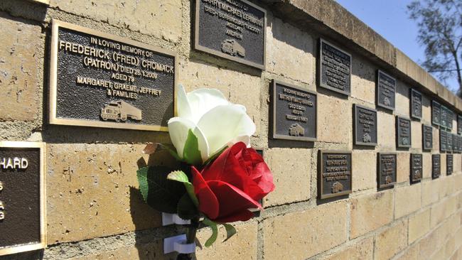 Families lay flowers and wreaths at the Truck Memorial at South Grafton.