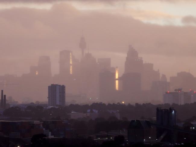 The sunrise looking from the airport towards the Sydney CBD. Photo: John Grainger