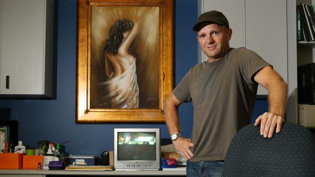 Pentagon Grand brothel owner Neil Gilmore in 2014 at his desk. Picture: Scott Fletcher.