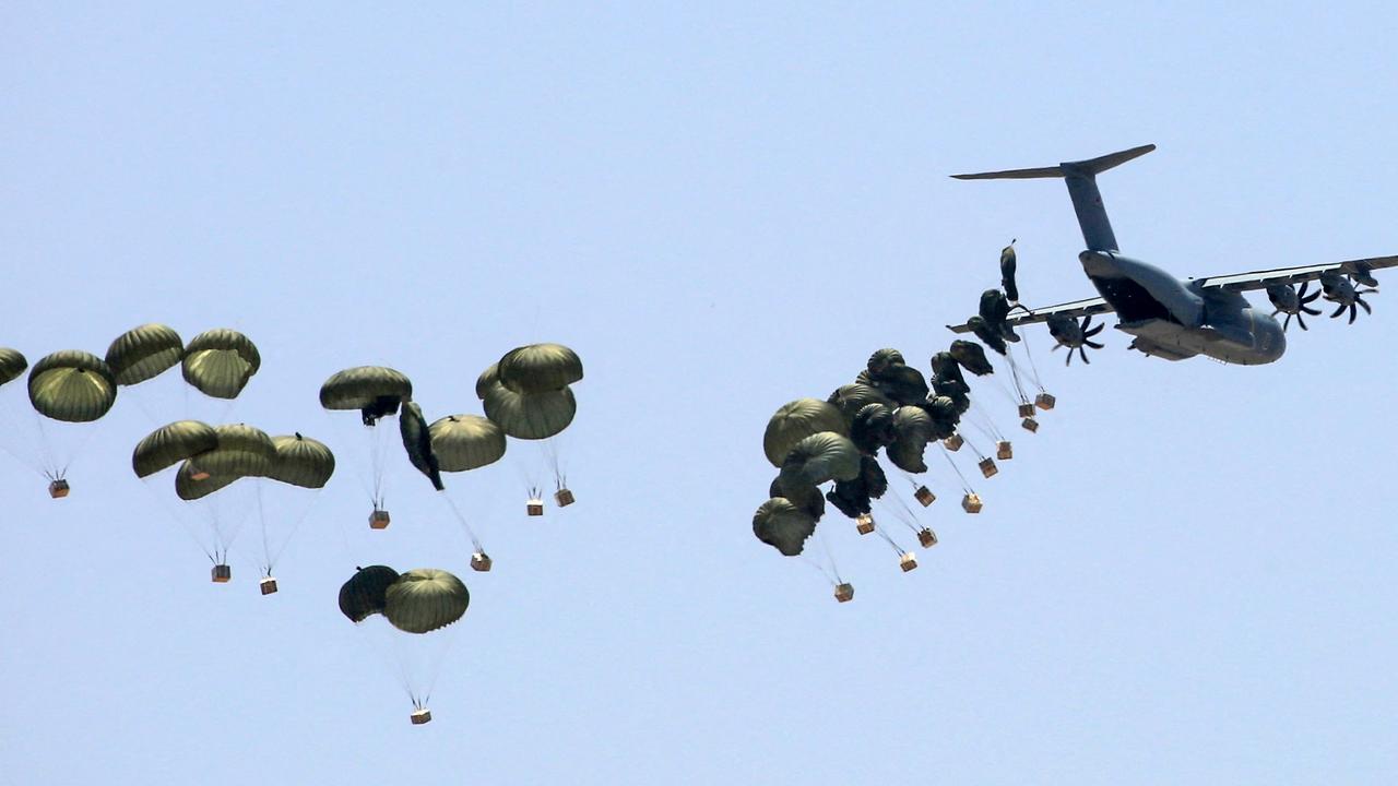 Humanitarian aid is dropped over Khan Yunis in the southern Gaza Strip on May 23, 2024, amid the ongoing conflict between Israel and the Palestinian Hamas group. (Photo by Eyad BABA / AFP)