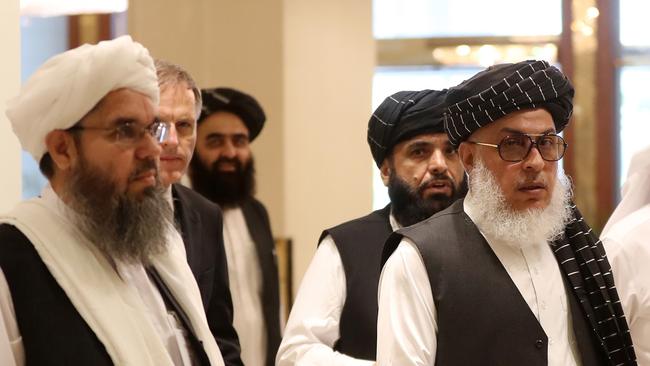 The Taliban's former envoy to Saudi Arabia Shahabuddin Delawar, left, arrives with Taliban negotiator Abbas Stanikzai, right, at the talks in Doha. Picture: AFP