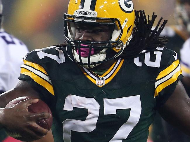 GREEN BAY, WI - OCTOBER 2: Eddie Lacy #27 of the Green Bay Packers runs for a first down as Anthony Barr #55 and Gerald Hodges #50 of the Minnesota Vikings chase him during the first quarter on October 02, 2014 at Lambeau Field in Green Bay, Wisconsin. The Packers defeated the Vikings 42-10. John Konstantaras/Getty Images/AFP == FOR NEWSPAPERS, INTERNET, TELCOS & TELEVISION USE ONLY ==
