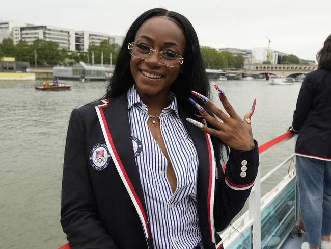 PARIS, FRANCE - JULY 26: Sha'Carri Richardson poses for a photo while riding with teammates on a boat with teammates along the Seine River during the Opening Ceremony of the Olympic Games Paris 2024 on July 26, 2024 in Paris, France. (Photo by Ashley Landis - Pool/Getty Images)