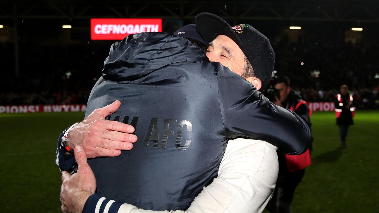 Ryan Reynolds and Rob McElhenney embrace.