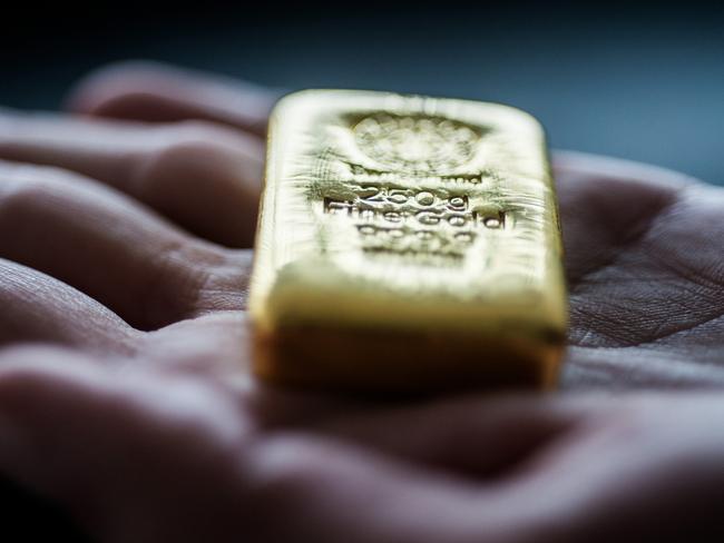 An employee holds a two hundred and fifty gram gold bar in this arranged photograph at Solar Capital Gold Zrt. in Budapest, Hungary, on Thursday, March 10, 2016. Gold advanced to the highest level in a year after the European Central Bank indicated it wouldn't cut interest rates further, boosting the euro and making dollar-denominated bullion less expensive for investors. Photographer: Akos Stiller/Bloomberg