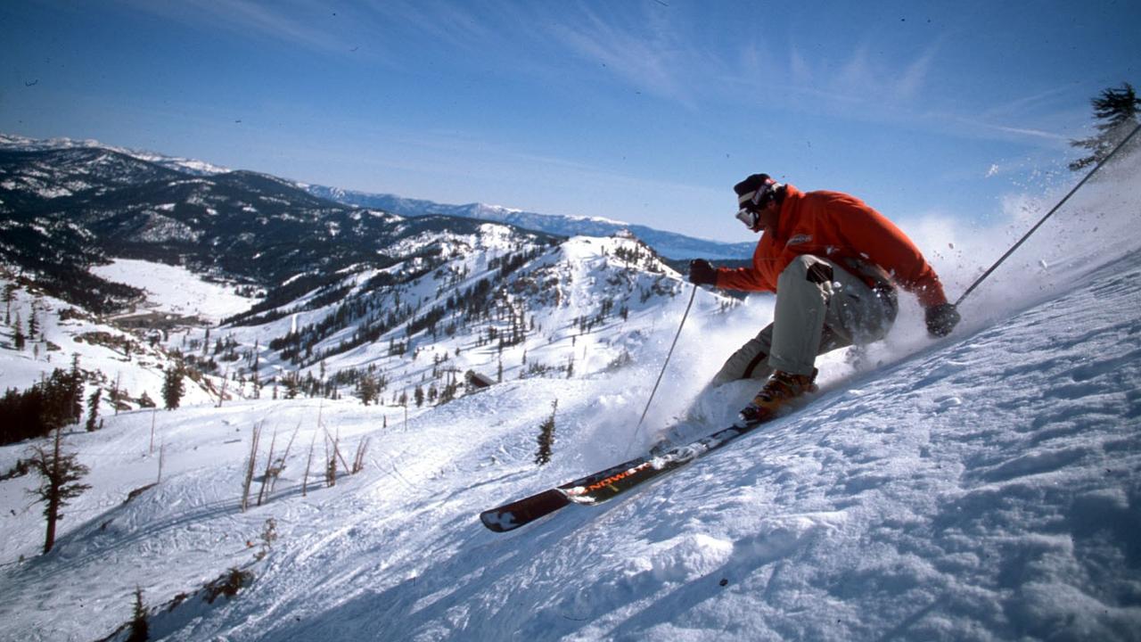 A snow skier above Squaw Valley Ski Resort at Lake Tahoe.