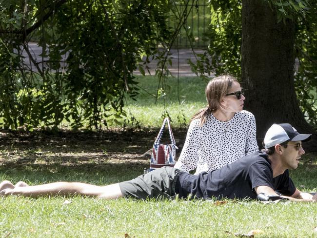 Pat Cummins and Rebecca Boston soaking up the sun in a park. Picture: Ella Pellegrini