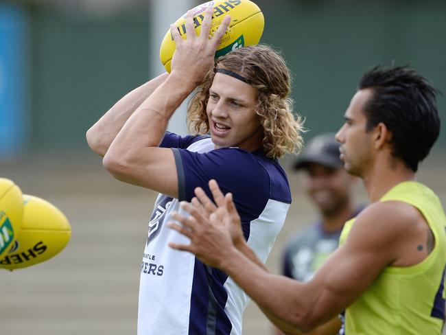 SPORT - The Fremantle Dockers train ahead of their season opener on Sunday. Photo by Daniel Wilkins. PICTURED- Nathan Fyfe does a handball drill