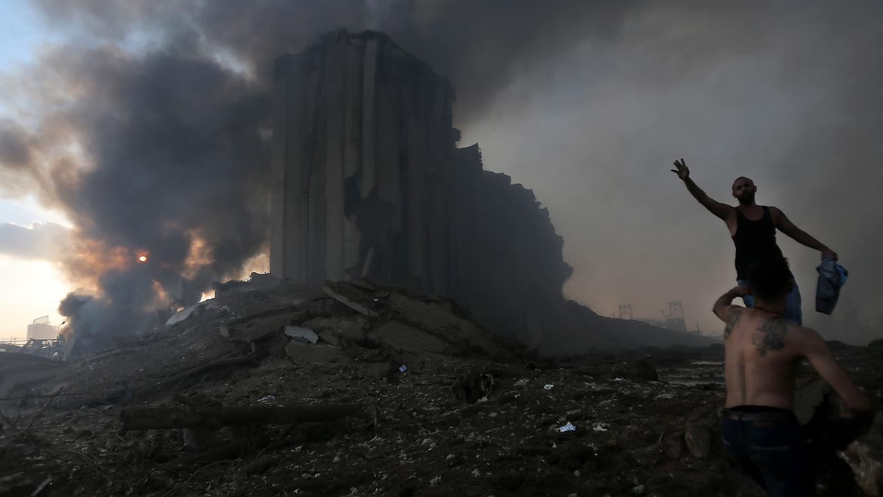 Two men at the scene of the blast. Picture: AFP