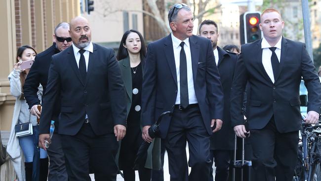 Xuan Dong is flanked by bodyguards outside the Supreme Court. Picture: Richard Dobson