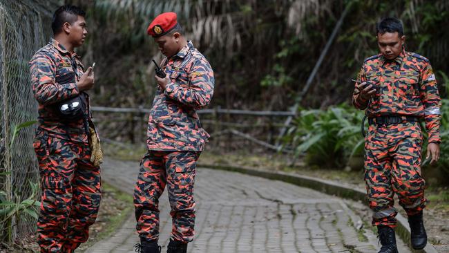 Members of a Malaysian rescue team listen to their radios at the Timpohon gate checkpoint a day after an earthquake in Kundasang, a town in the district of Ranau. Picture: AFP