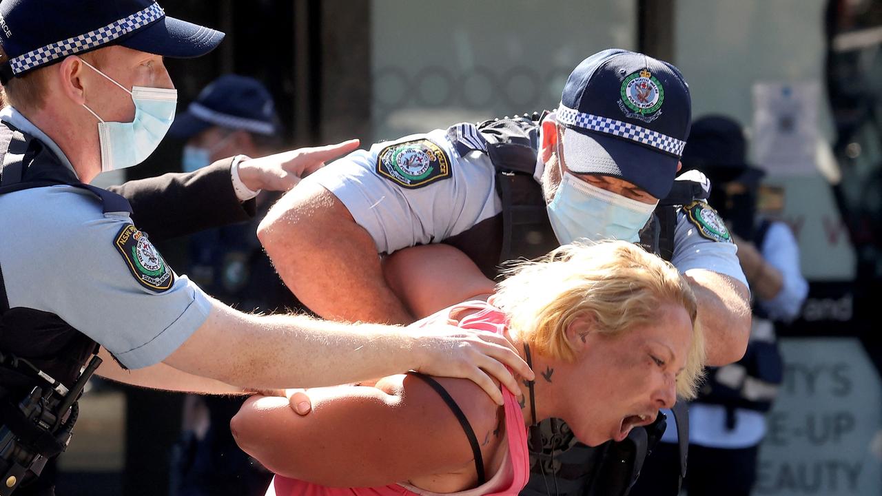 Police officers detain a protester in Sydney following calls for an anti-lockdown protest rally amid a fast-spreading coronavirus outbreak. Picture: AFP