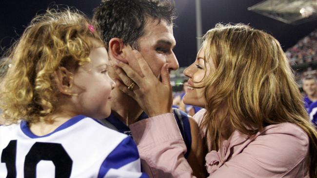 Anthony Stevens embraces wife Kelli and daughter Ayva.