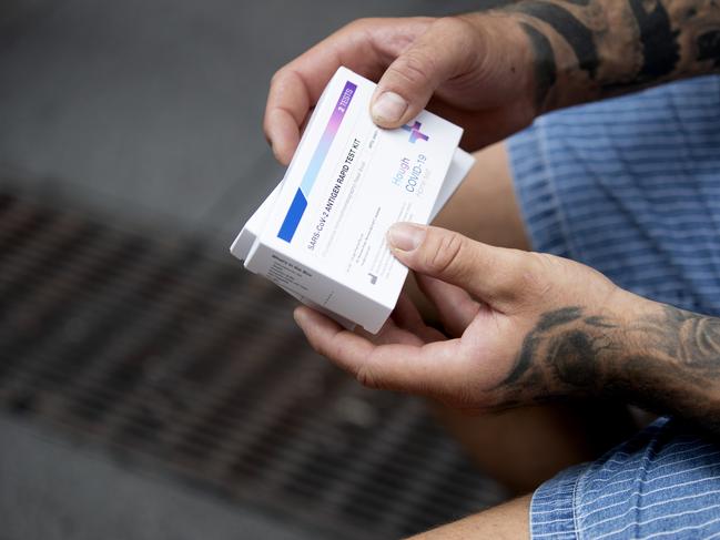 SYDNEY, AUSTRALIA - NewsWire Photos JANUARY 13, 2022: A customer holds his rapid antigen tests after purchasing them from a chemist in Sydney. Australians are dealing with low supplies following the surge in COVID cases across the country. Picture: NCA NewsWire / Nikki Short