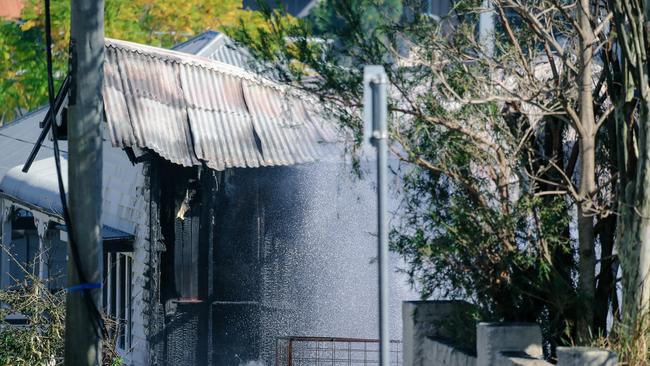 Water splashed onto the home as the clean-up continued. Picture: NCA NewsWire/Glenn Campbell