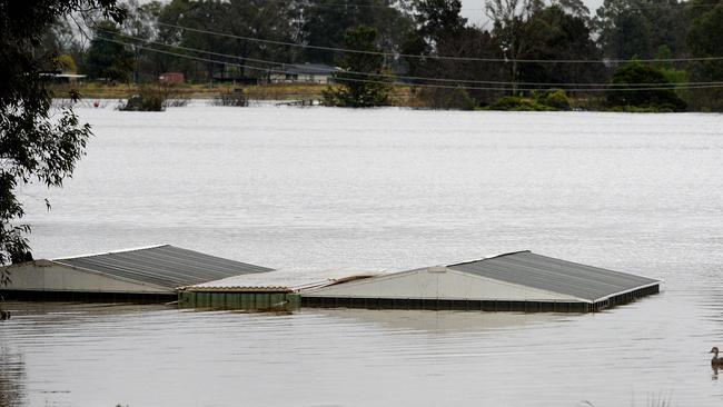 The roof a flooded house near the overflowing Hawkesbury River this winter. Picture: Muhammad FAROOQ / AFP