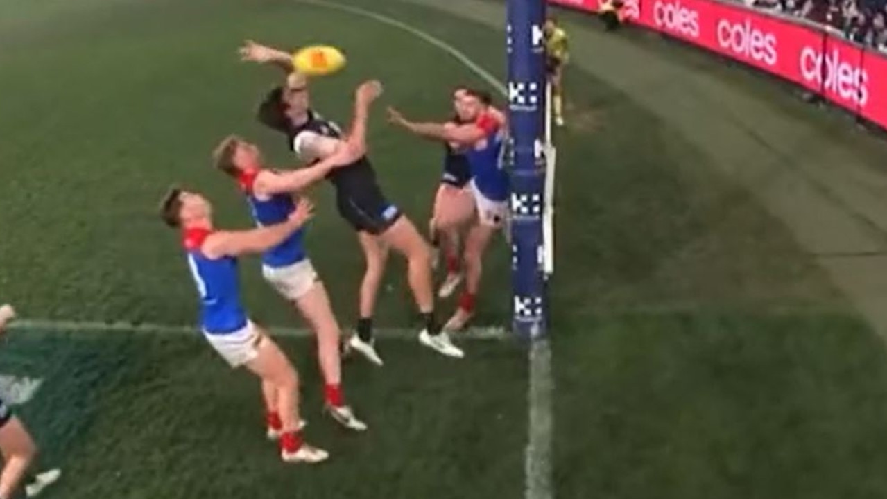 Caleb Marchbank claims a touch on Christian Petracca shot on goal. And it came back to an umpire’s call for the result.