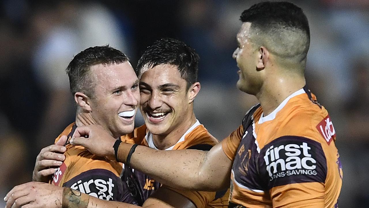 Kotoni Staggs and David Fifita celebrate with Jake Turpin (left), the last-minute hero in their victory over the Cowboys. Picture: Ian Hitchcock/Getty Images