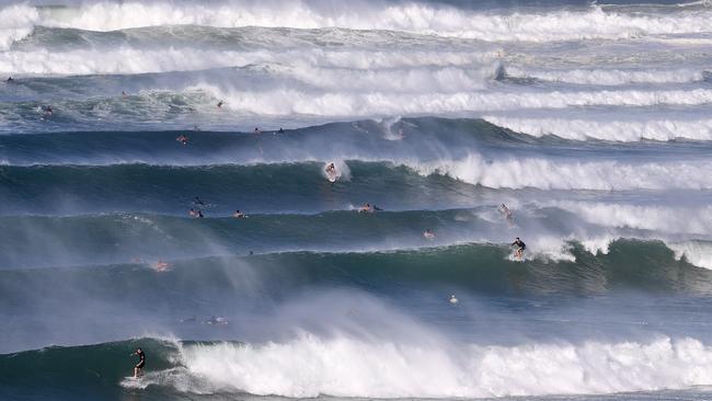 Surfers at Kirra on the Gold Coast when Cyclone Oma sat off the Queensland coast in 2019. Picture: AAP/Dave Hunt