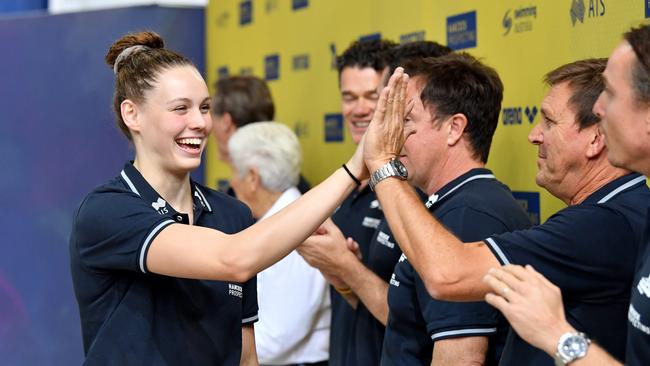 Swimmer Minna Atherton (left), after earning a place on the Australian team for this year’s world championships, high fives with Michael Bohl. (AAP Image/Darren England)