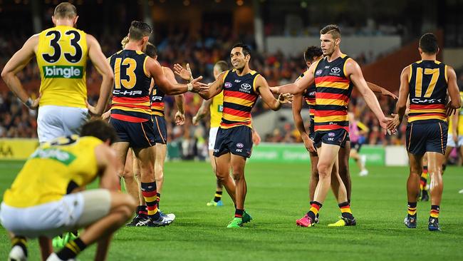 Taylor Walker, Eddie Betts and Josh Jenkins celebrate a goal.