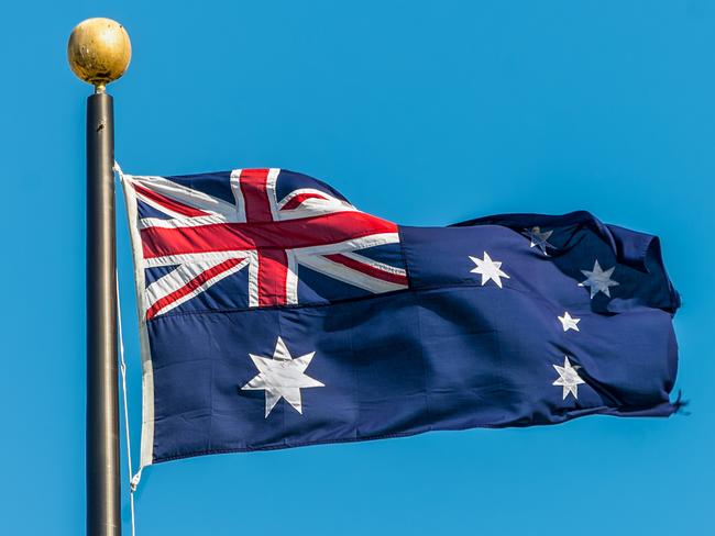 The Australian flag against clear blue sky