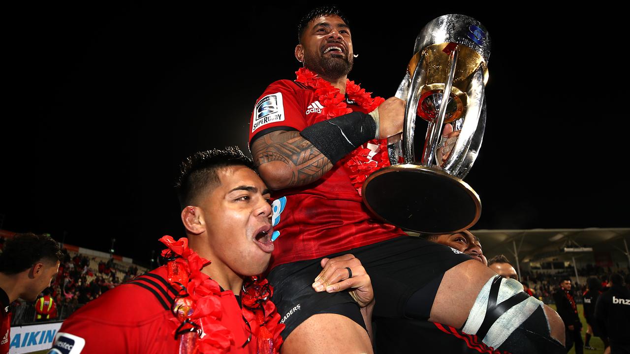 Jordan Taufua of the Crusaders holds up the Super Rugby trophy.